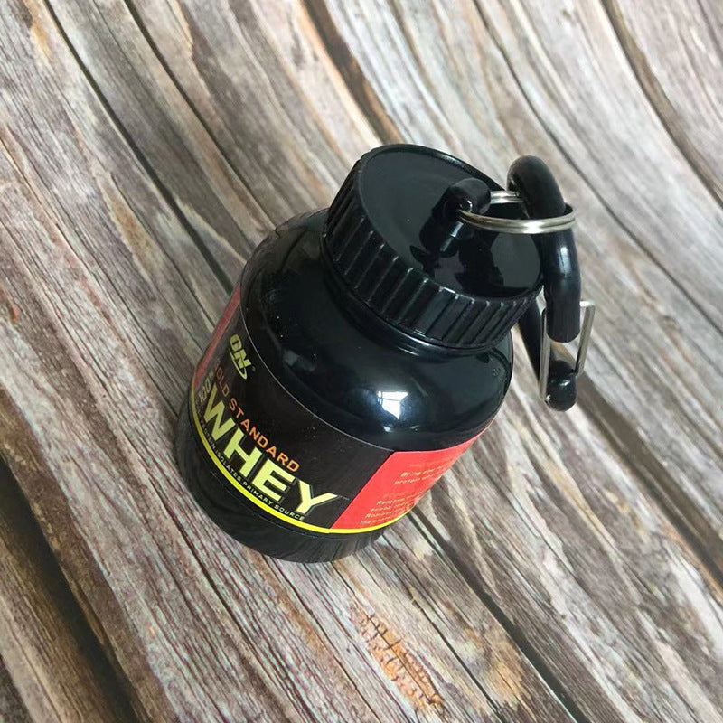 Black and red container labeled 'Whey' on a wooden surface